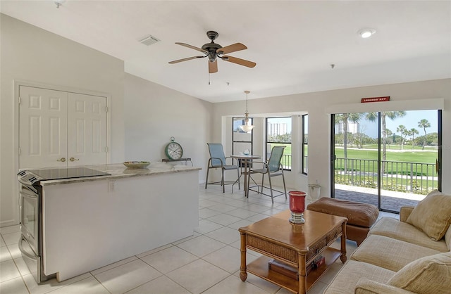 tiled living room featuring ceiling fan