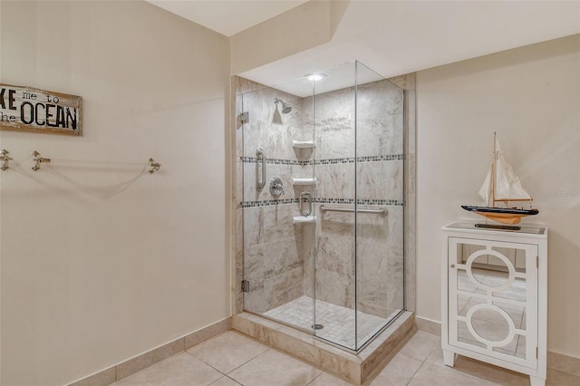 bathroom with tile floors and a shower with shower door