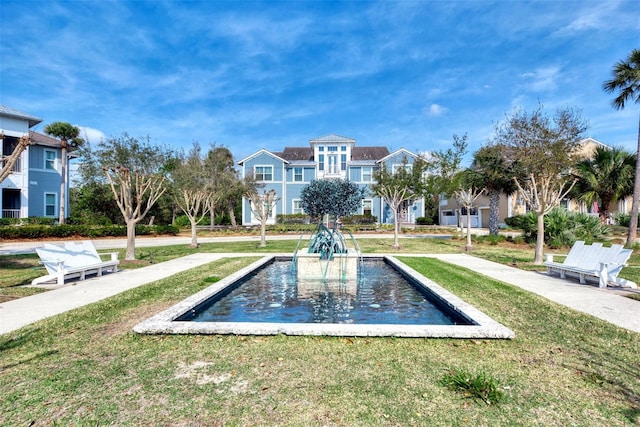 view of property's community with a lawn