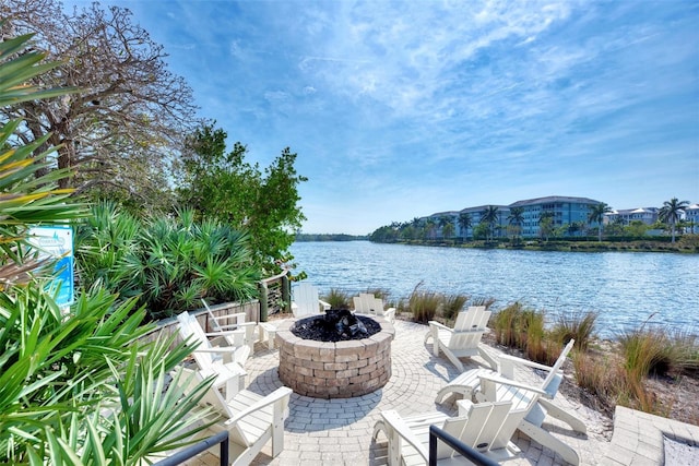 view of patio with a water view and an outdoor fire pit