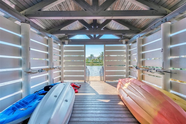 interior space with a water view and wooden ceiling