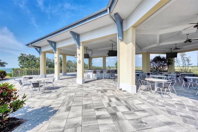 view of patio / terrace featuring ceiling fan and exterior bar