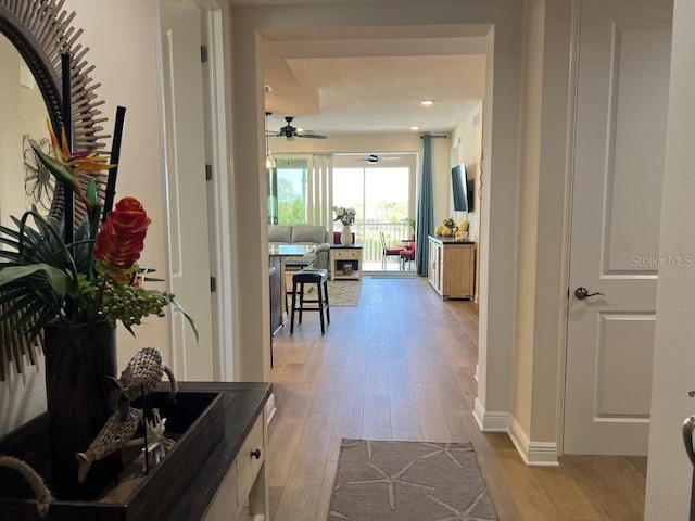 corridor with light hardwood / wood-style floors