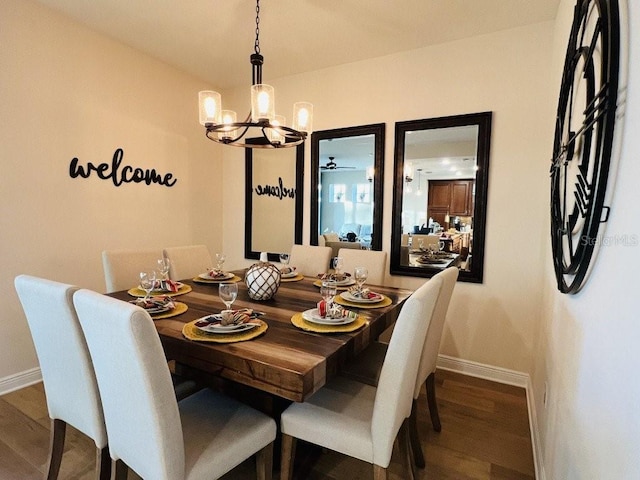 dining space featuring ceiling fan with notable chandelier and wood-type flooring