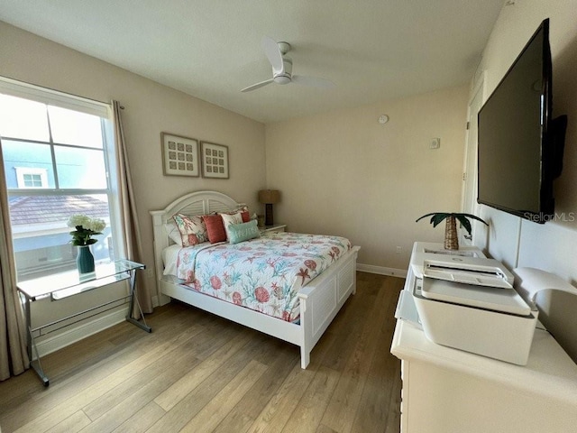 bedroom with ceiling fan and wood-type flooring