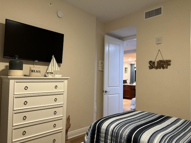 bedroom with wood-type flooring