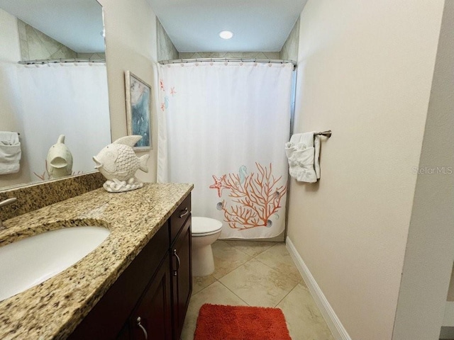 bathroom with tile patterned flooring, vanity, and toilet