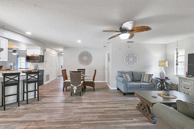 living room with hardwood / wood-style flooring and a textured ceiling