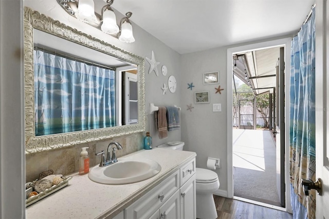 bathroom featuring vanity, toilet, and wood-type flooring