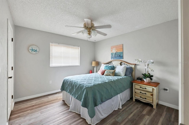 bedroom with hardwood / wood-style floors, ceiling fan, and a textured ceiling