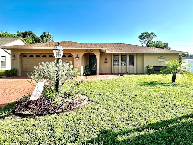 ranch-style house featuring a front yard and a garage