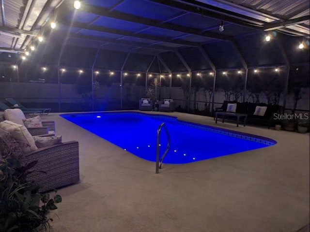 view of pool with a lanai, a patio area, and outdoor lounge area