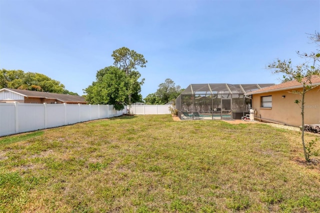 view of yard featuring a fenced in pool and a lanai