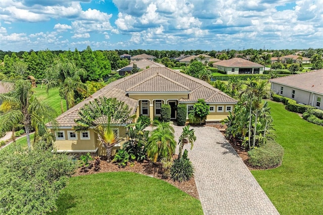 mediterranean / spanish-style house with a front yard