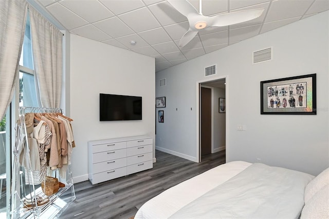 bedroom featuring a paneled ceiling, ceiling fan, and dark wood-type flooring