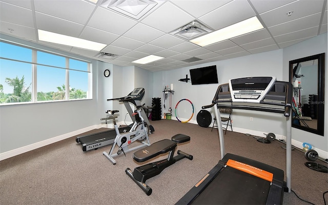 workout room with a paneled ceiling