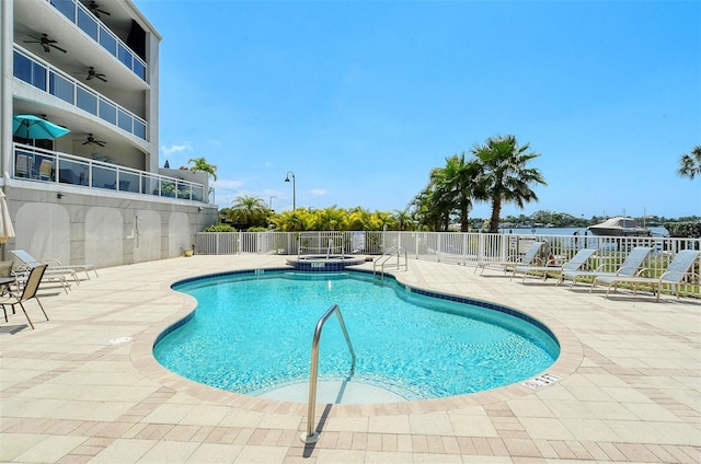 view of swimming pool featuring a community hot tub and a patio