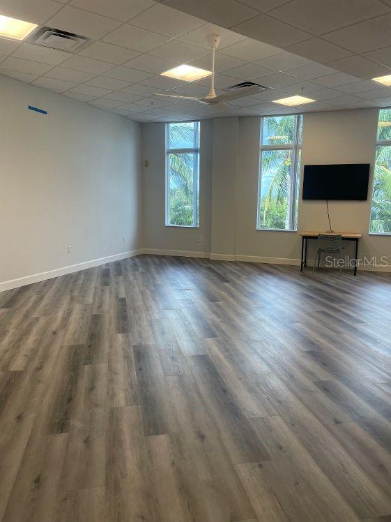 spare room featuring a paneled ceiling and wood-type flooring