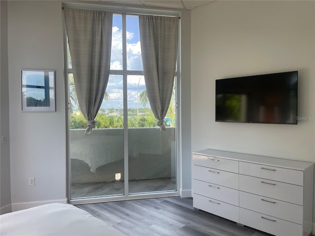 unfurnished bedroom with hardwood / wood-style flooring and multiple windows