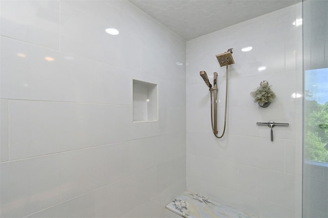 bathroom with tiled shower