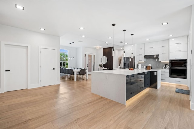 kitchen featuring stainless steel fridge with ice dispenser, white cabinetry, a center island, and light hardwood / wood-style floors