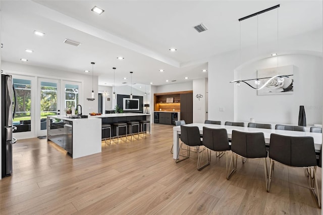 dining area featuring light hardwood / wood-style floors and sink