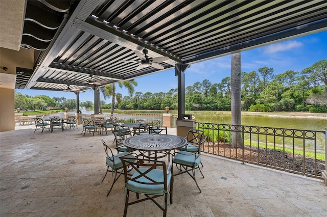 view of patio with a water view, ceiling fan, and a pergola