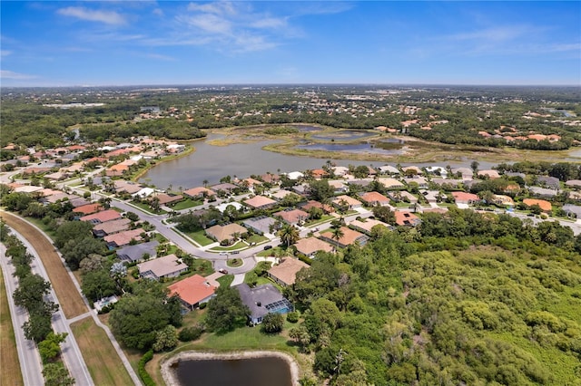 drone / aerial view featuring a water view and a residential view