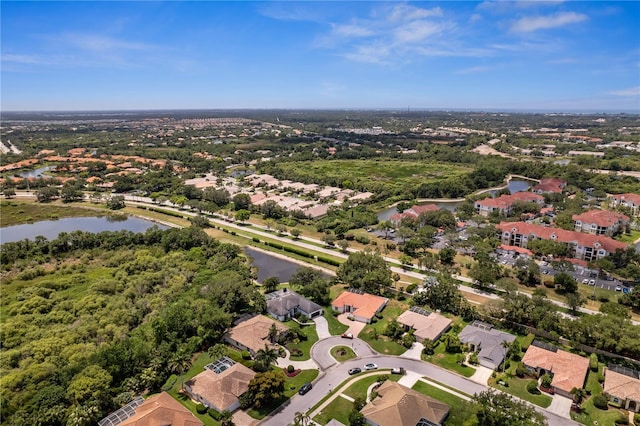 birds eye view of property with a residential view and a water view