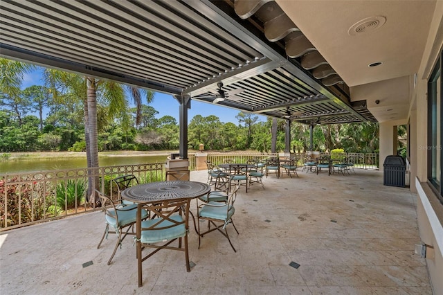 view of patio / terrace featuring a water view, visible vents, outdoor dining area, and a pergola