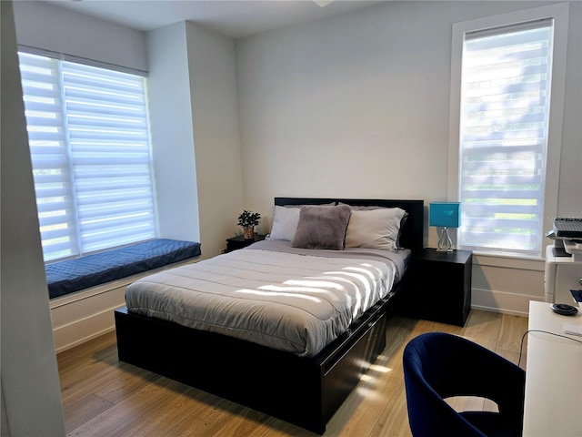 bedroom with baseboards and wood finished floors