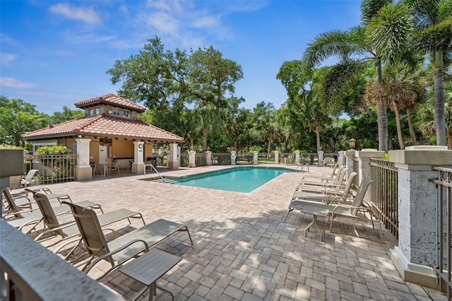 pool with a patio, a gazebo, and fence