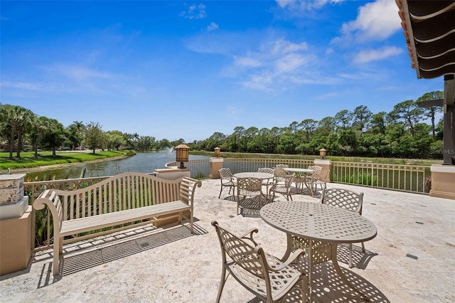 view of patio featuring a water view and outdoor dining space