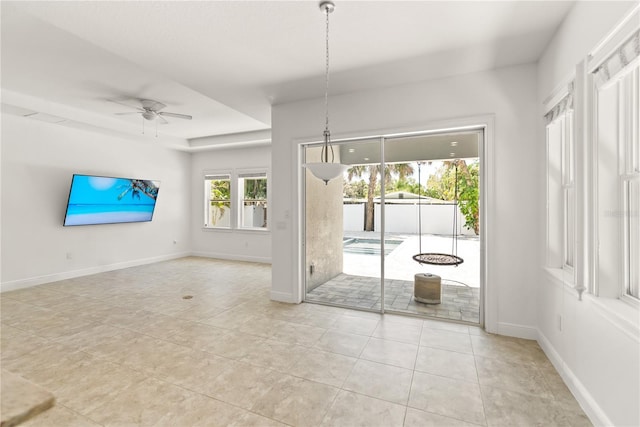 unfurnished dining area with ceiling fan and light tile patterned flooring