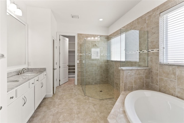 bathroom featuring plus walk in shower and vanity