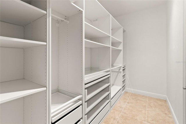 spacious closet featuring light tile patterned flooring