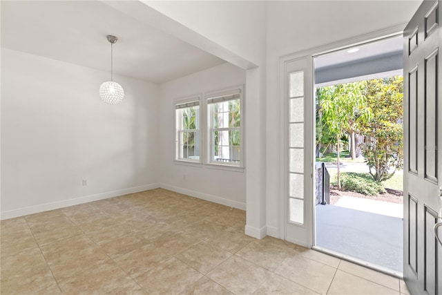 tiled entryway featuring an inviting chandelier