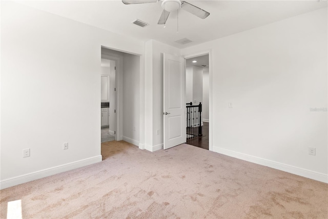 unfurnished bedroom with ceiling fan and carpet