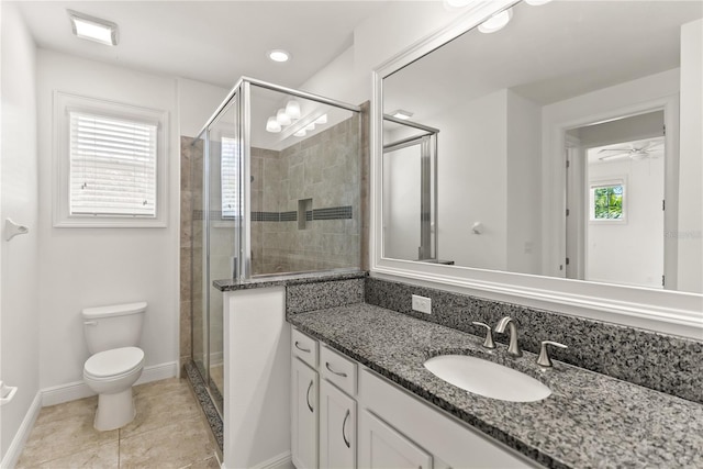 bathroom featuring vanity, toilet, tile patterned flooring, and an enclosed shower