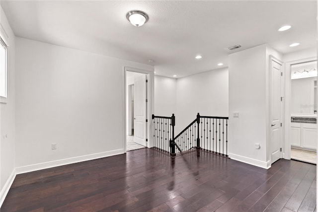 empty room featuring dark wood-type flooring