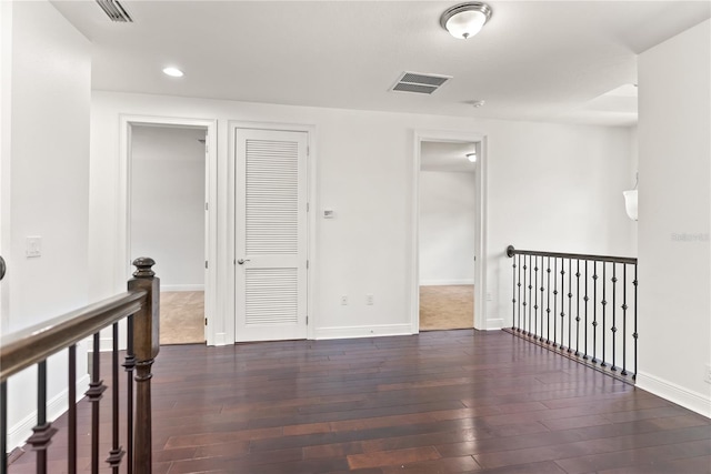 unfurnished room with dark hardwood / wood-style flooring