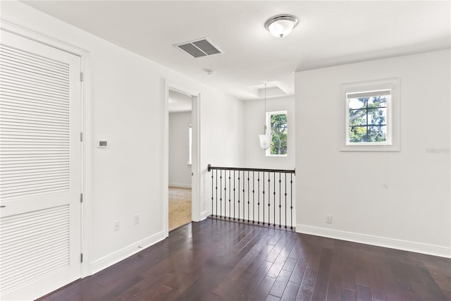 empty room with dark hardwood / wood-style floors