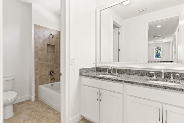 full bathroom featuring toilet, tiled shower / bath combo, tile patterned floors, and vanity