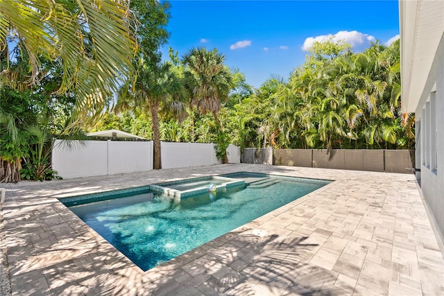 view of swimming pool with a patio and an in ground hot tub