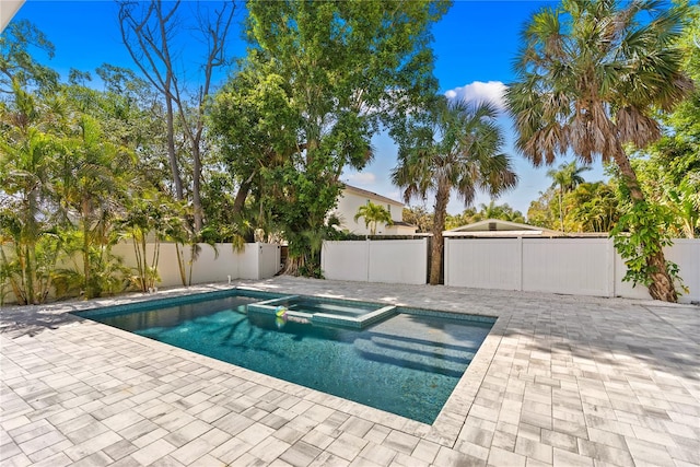 view of pool with an in ground hot tub and a patio