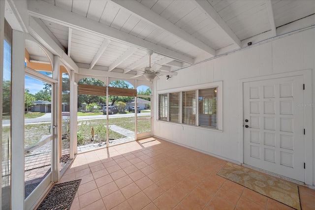 unfurnished sunroom with beamed ceiling and ceiling fan