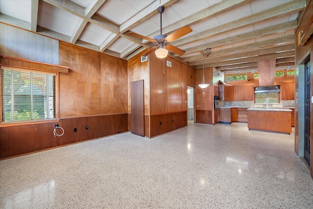 spare room featuring beam ceiling and ceiling fan