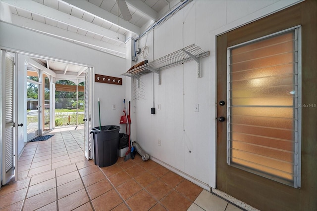 interior space featuring beam ceiling and tile flooring