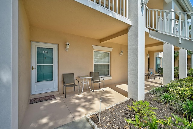 doorway to property featuring a patio area and a balcony