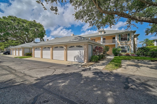 view of front of home featuring a garage and a balcony